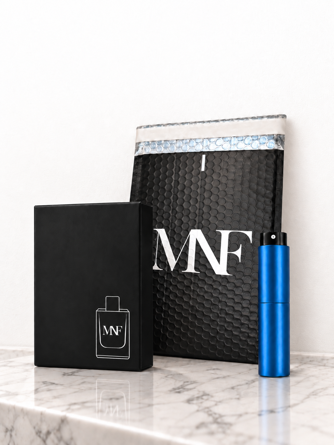 MNF mailer, presentation box, and blue Travel Spray