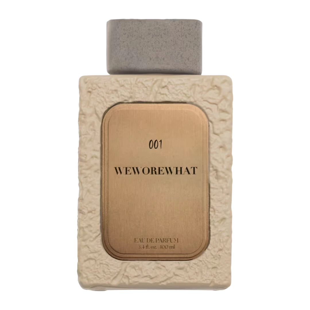 My Next Fragrance WeWoreWhat 001 Eau de Parfum bottle with textured cream casing and metallic gold label